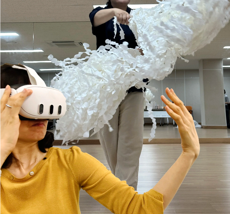 Participant wearing a VR headset and engaging with the performance